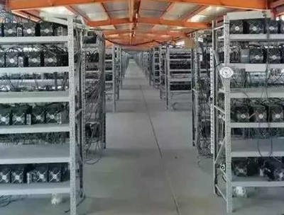 Exterior of a large mining farm with visible cooling infrastructure.